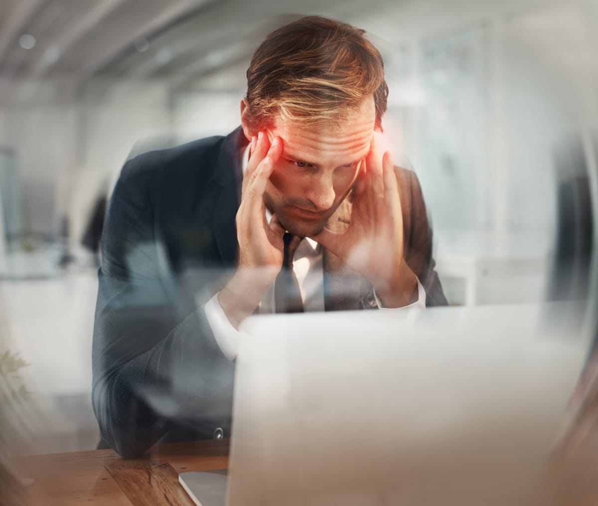Laptop, blur and business man with headache, stress and deadline at night in office. Pain, sick and tired employee with migraine on computer, vertigo and massage temples for brain fog with red glow birth trauma